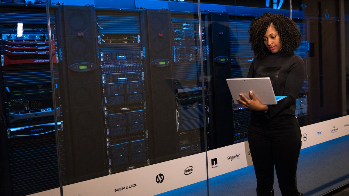 Engineer beside server racks