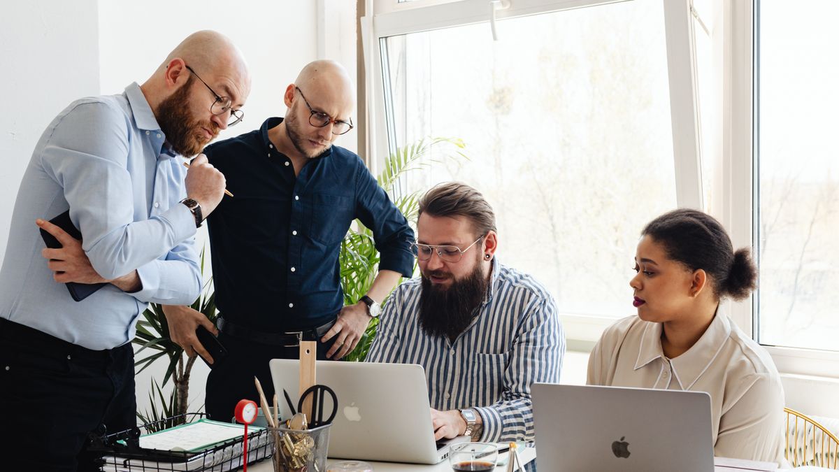 A team looking at a laptop together