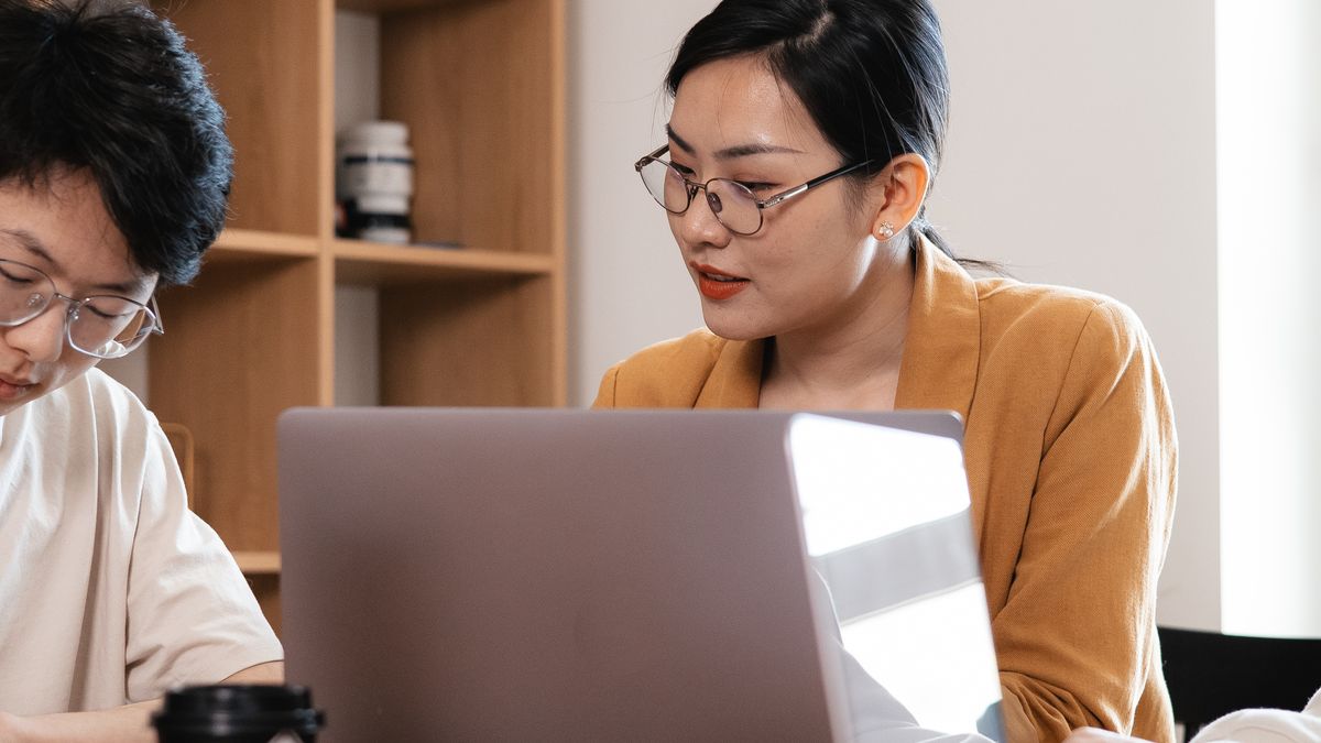 Two colleagues working at a laptop
